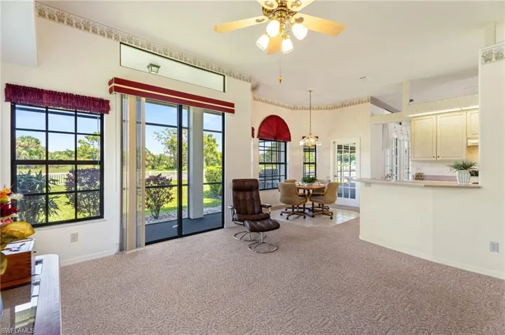 Living area with french doors, a ceiling fan, and high vaulted ceiling