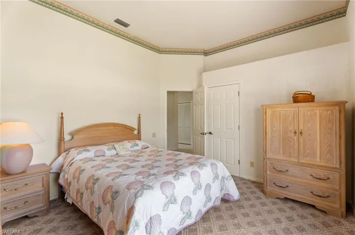 Full bathroom with a shower stall, wainscoting, vanity, wallpapered walls, and light tile patterned floors