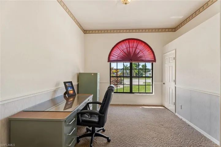 Unfurnished office featuring carpet flooring and wainscoting