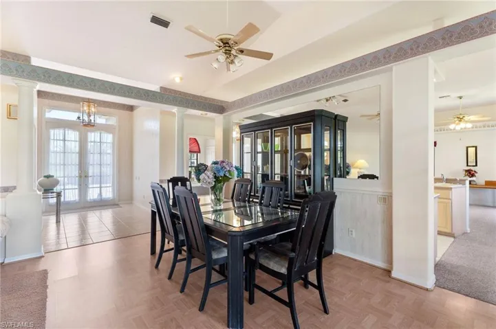 Back of property with a sunroom, stucco siding, and a shingled roof