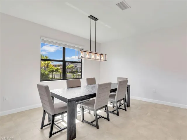 Dining room with baseboards and a chandelier