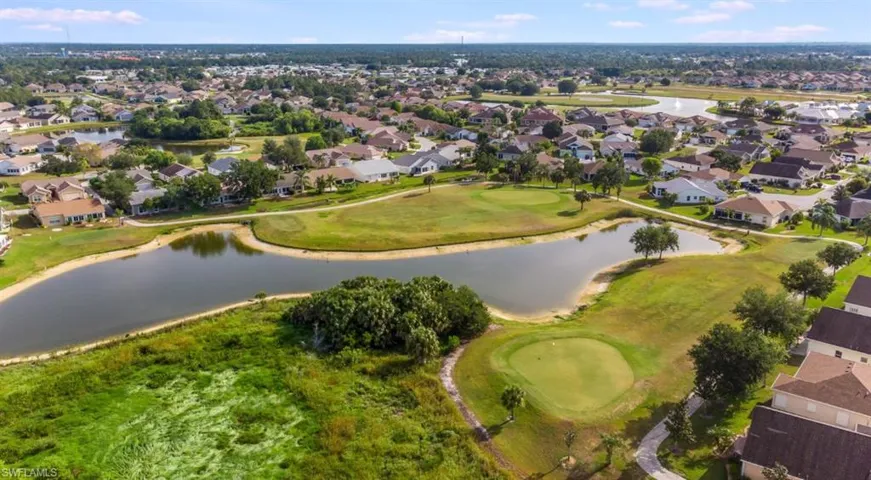 Drone / aerial view with a residential view, a water view, and view of golf course