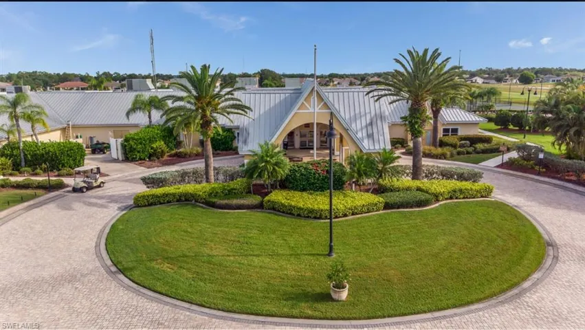 View of building exterior featuring curved driveway