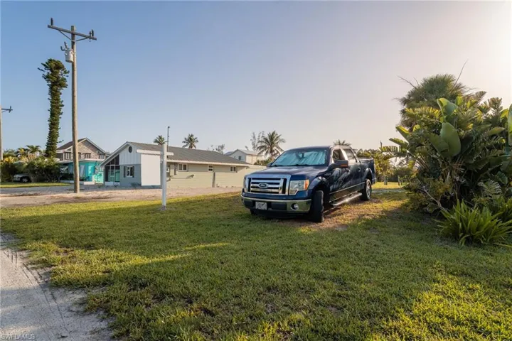View of front of house featuring a front lawn and board and batten siding