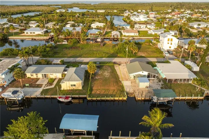 Aerial view of residential area featuring a large body of water
