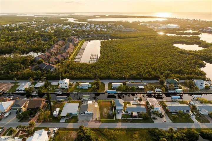 Aerial view of residential area featuring a nearby body of water