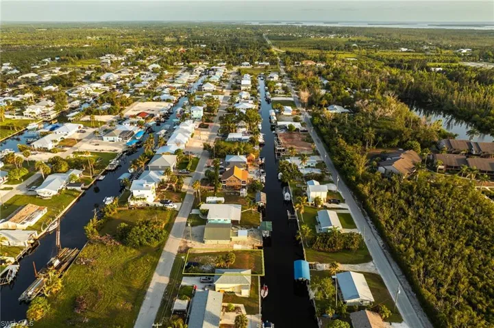 Aerial overview of property's location with a nearby body of water and nearby suburban area