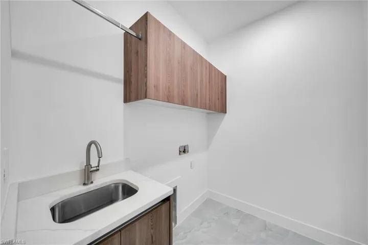 Laundry area featuring hookup for a washing machine and cabinet space