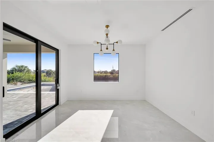 Unfurnished dining area featuring hanging lights and baseboards