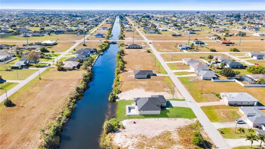 Aerial view of property's location with nearby suburban area and a nearby body of water