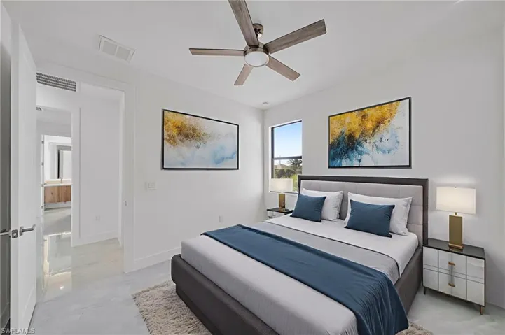 Bedroom with ceiling fan and finished concrete flooring