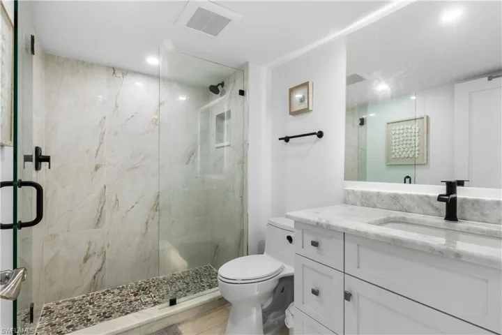 Totally updated bathroom with over-sized shower and accent lighting.  Marble counertops.