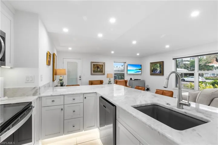 Kitchen photo showing counter tops, range, microwave, dishwasher and under-counter over-sized sink.