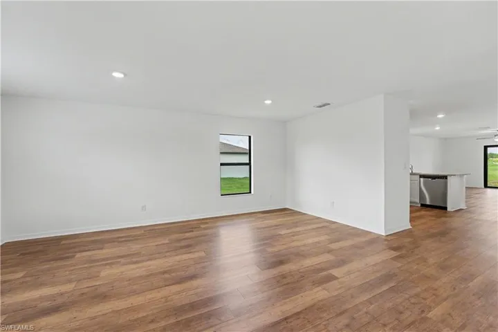 Spacious interior featuring wood-finish flooring, recessed lighting, and a neutral color palette