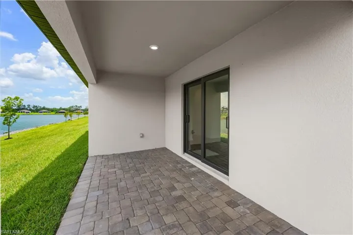 Covered patio featuring paver flooring and recessed lighting