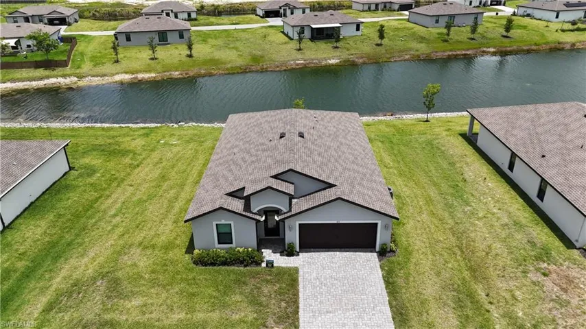 Single-story residence featuring a gray exterior and a brown garage door
