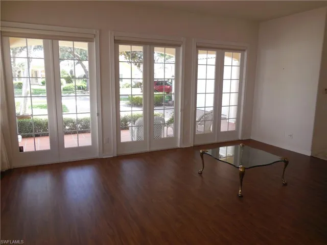 Doorway featuring wood finished floors and baseboards