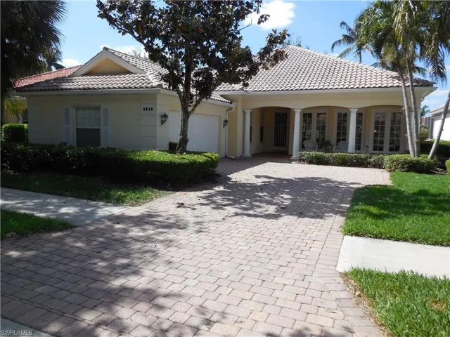 Mediterranean / spanish-style house featuring a garage, driveway, a tiled roof, and stucco siding