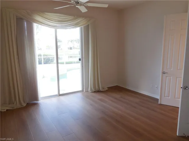 Unfurnished room with baseboards, a ceiling fan, and wood finished floors