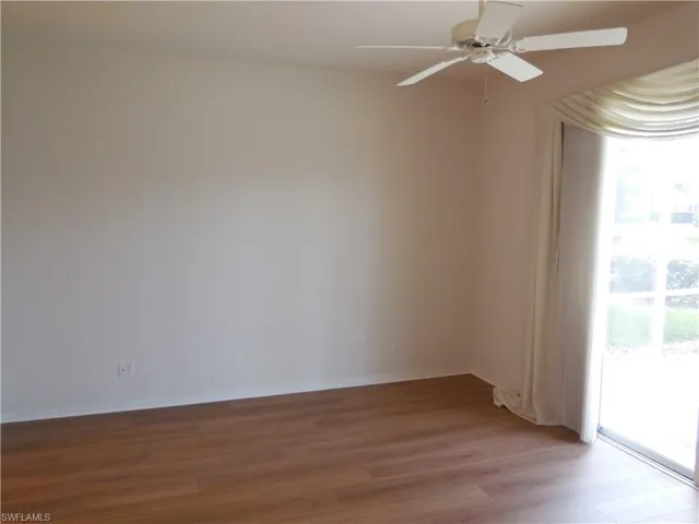 Unfurnished room with light wood-style floors, ceiling fan, and baseboards
