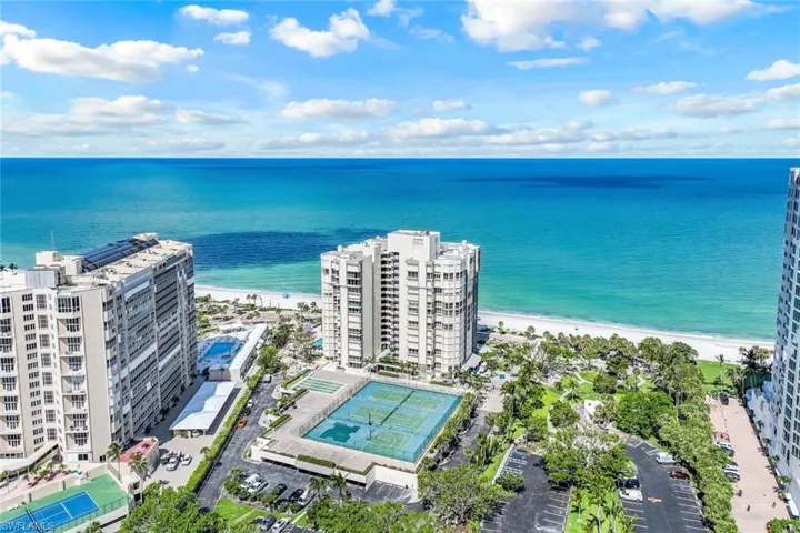 Bird's eye view of expansive beach and apartment complex