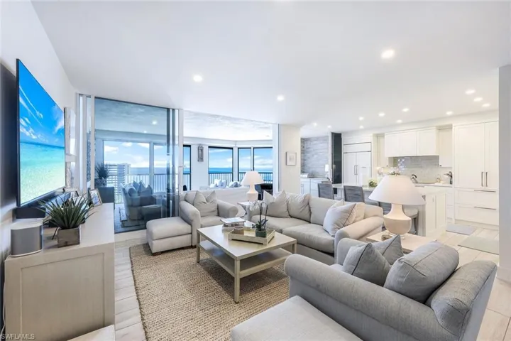 Living room featuring floor to ceiling windows, recessed lighting, and light wood-type flooring