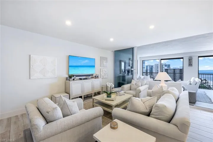 Living area featuring light wood-style flooring and recessed lighting