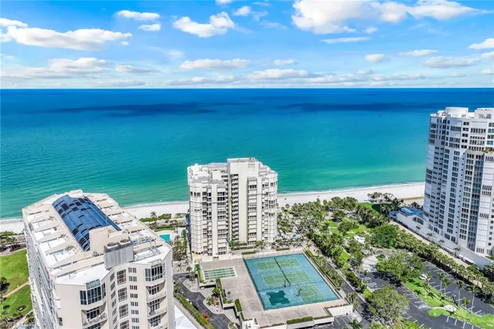Drone / aerial view of unending shoreline and a pool