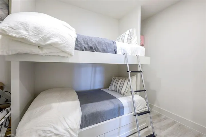 Bedroom featuring wood finished floors and baseboards