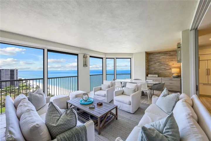 Living room featuring a water view and a textured ceiling