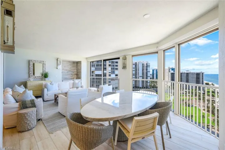 Sunroom / solarium with a water view and a view of city