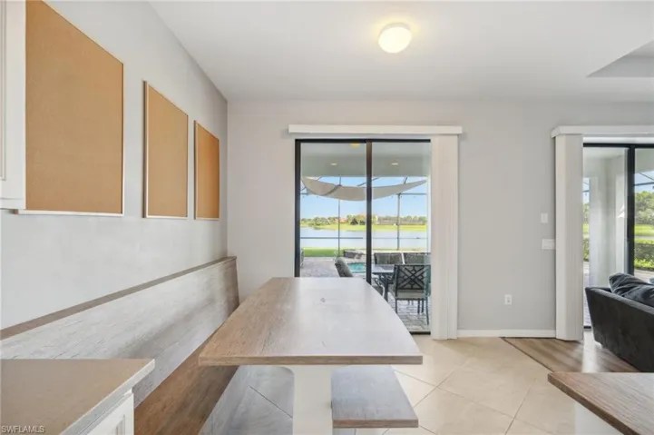 Dining area with pool and water view