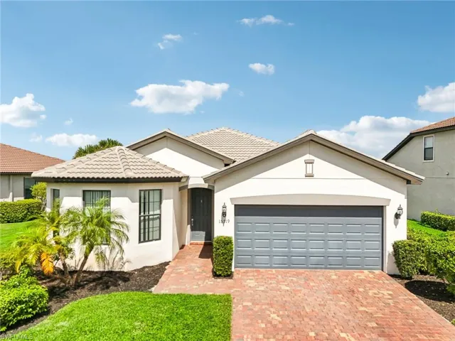 View of front of home featuring a garage and a front lawn