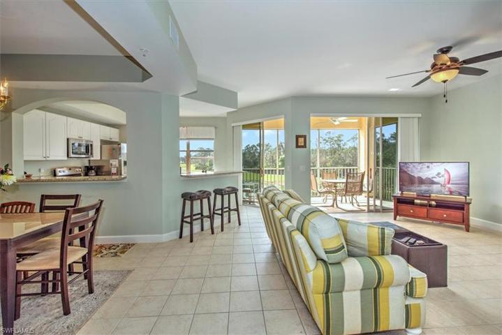Open concept living area overlooks kitchen, dining room and waterfront screened lanai!