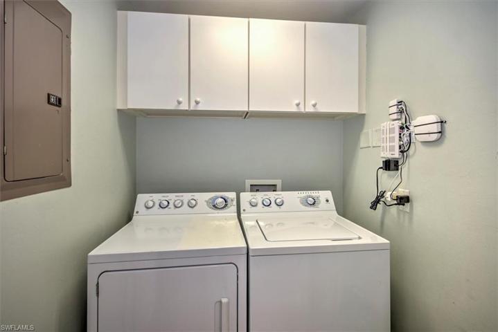 Full size laundry room includes storage cabinetry!