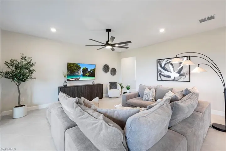 Tiled living room featuring ceiling fan