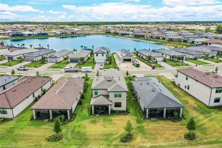 Birds eye view of property with a water view