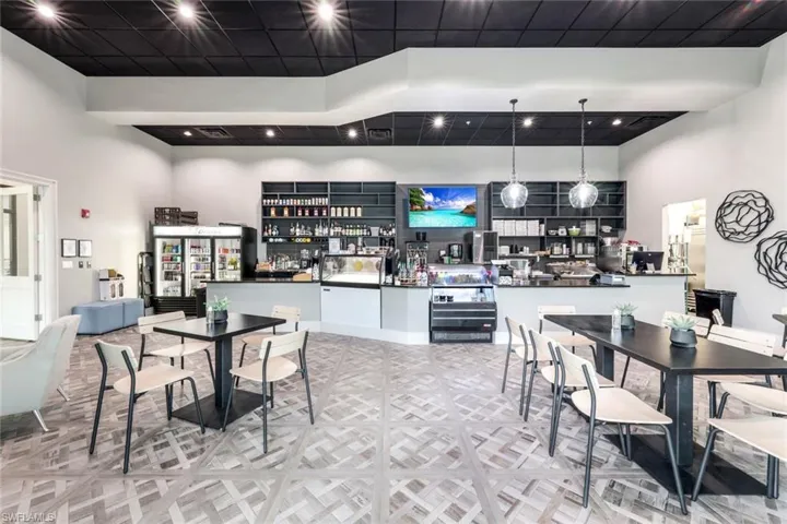 Dining area featuring a high ceiling and bar area