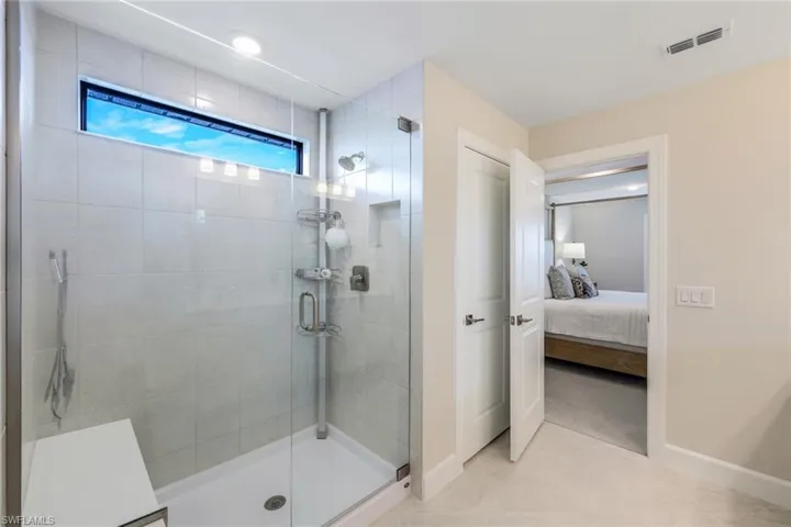Bathroom featuring walk in shower and tile flooring
