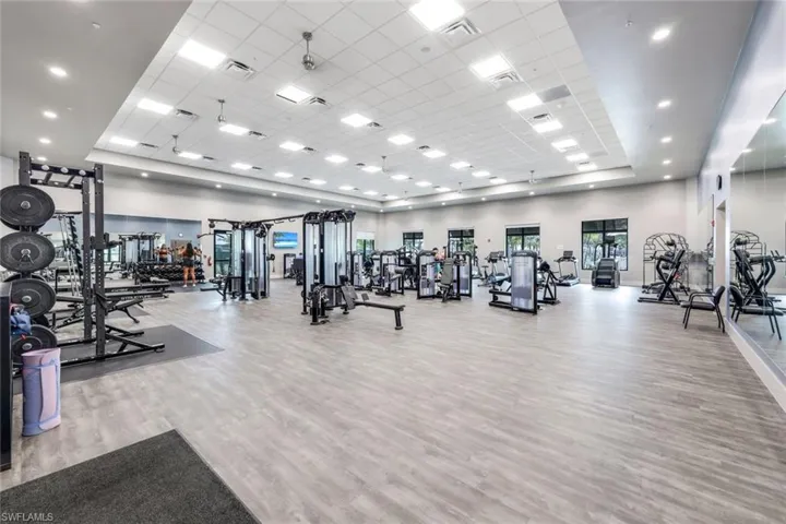 Exercise room featuring light hardwood / wood-style flooring and a drop ceiling