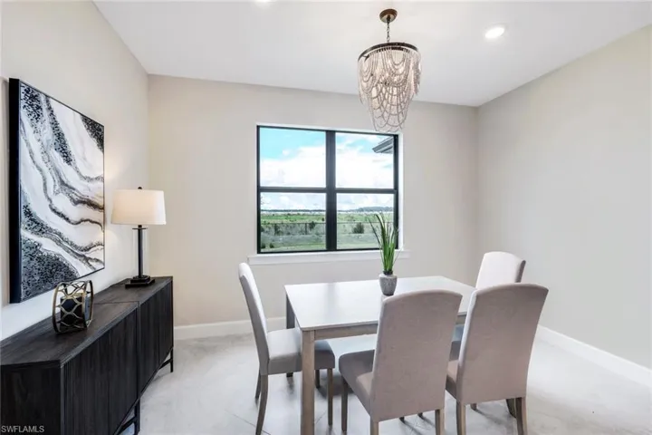 Dining space featuring a notable chandelier and light tile flooring