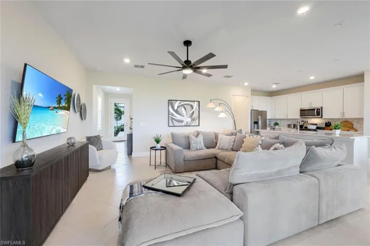Tiled living room featuring ceiling fan
