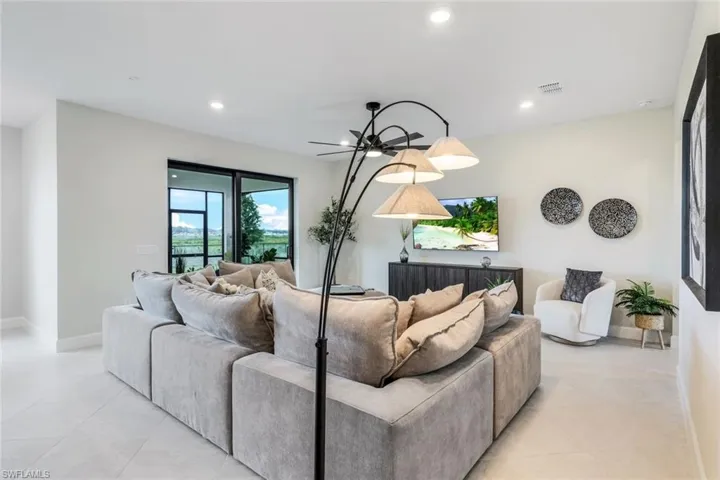 Tiled living room featuring ceiling fan