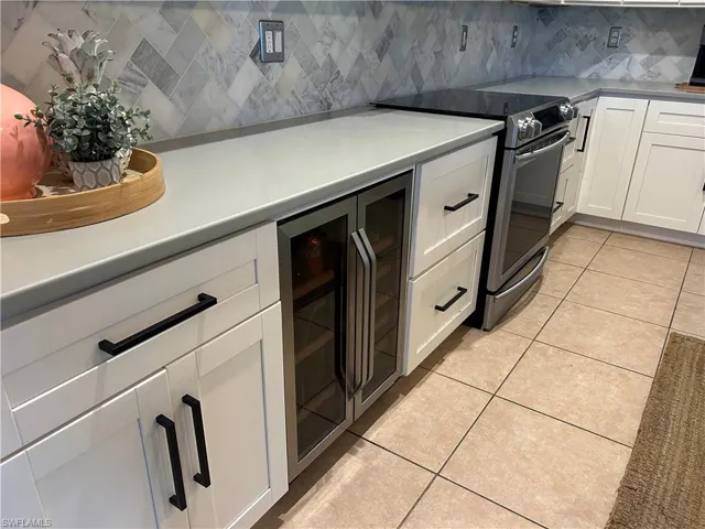 White Kitchen with Iron Hardware and wine cooler