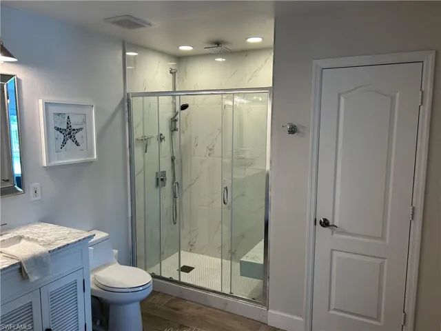 marble shower with glass doors and Rain shower head