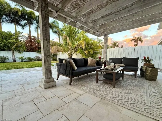 Fenced backyard with an outdoor hangout area and a patio