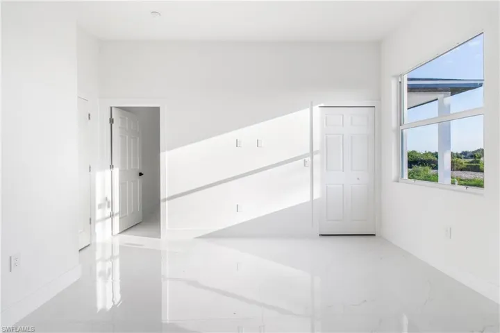 Spare room with marble tiled floors and baseboards