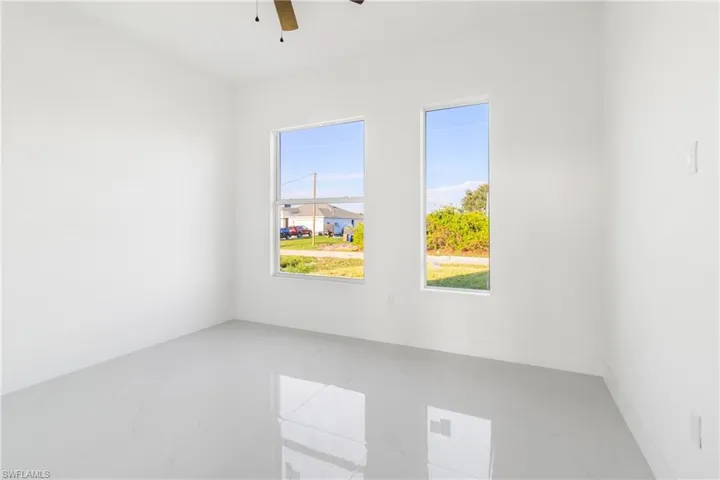 Unfurnished room with ceiling fan and marble finish flooring