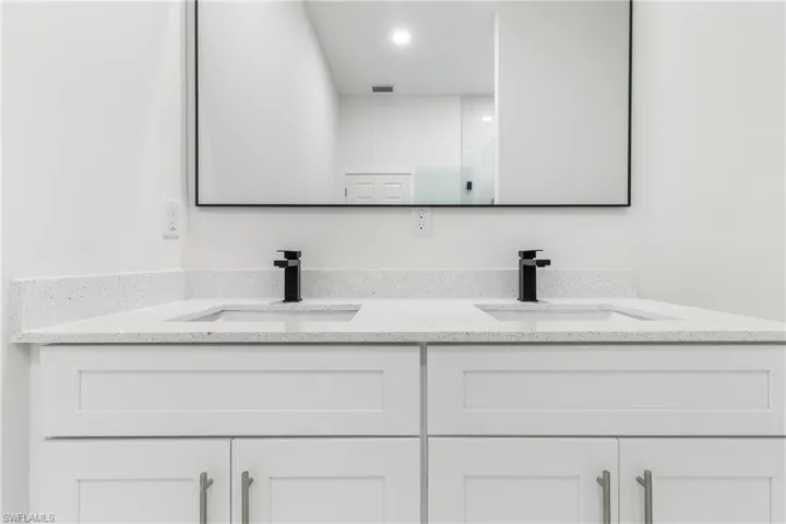 Bathroom with double vanity and recessed lighting