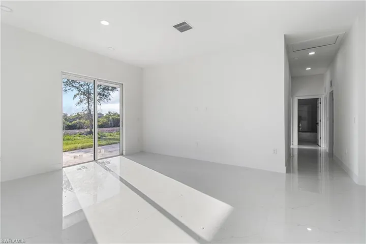 Spare room with recessed lighting, baseboards, and light marble finish flooring